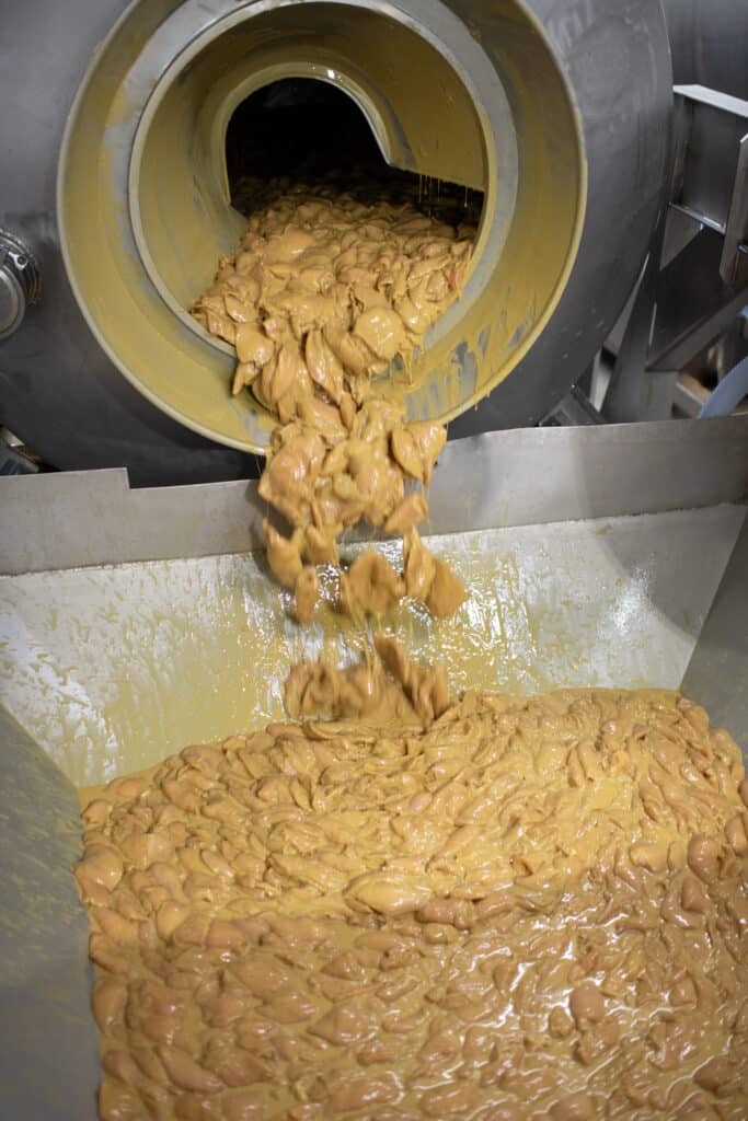 marinated chicken being processed