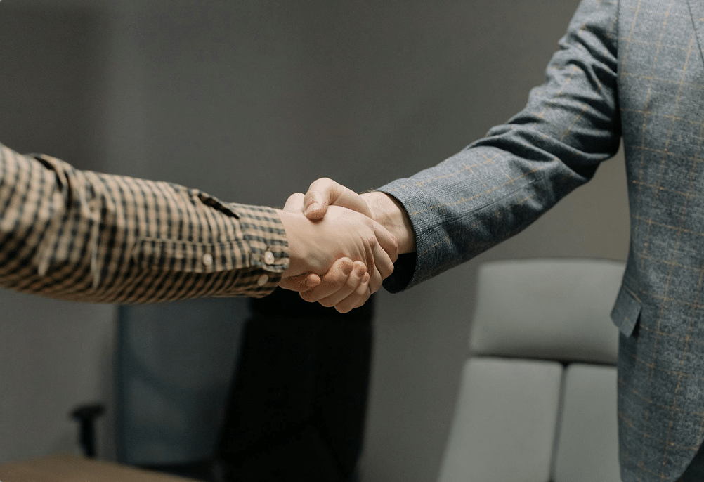 A handshake between two men in business clothes