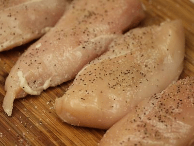 Raw chicken tenders with seasoning